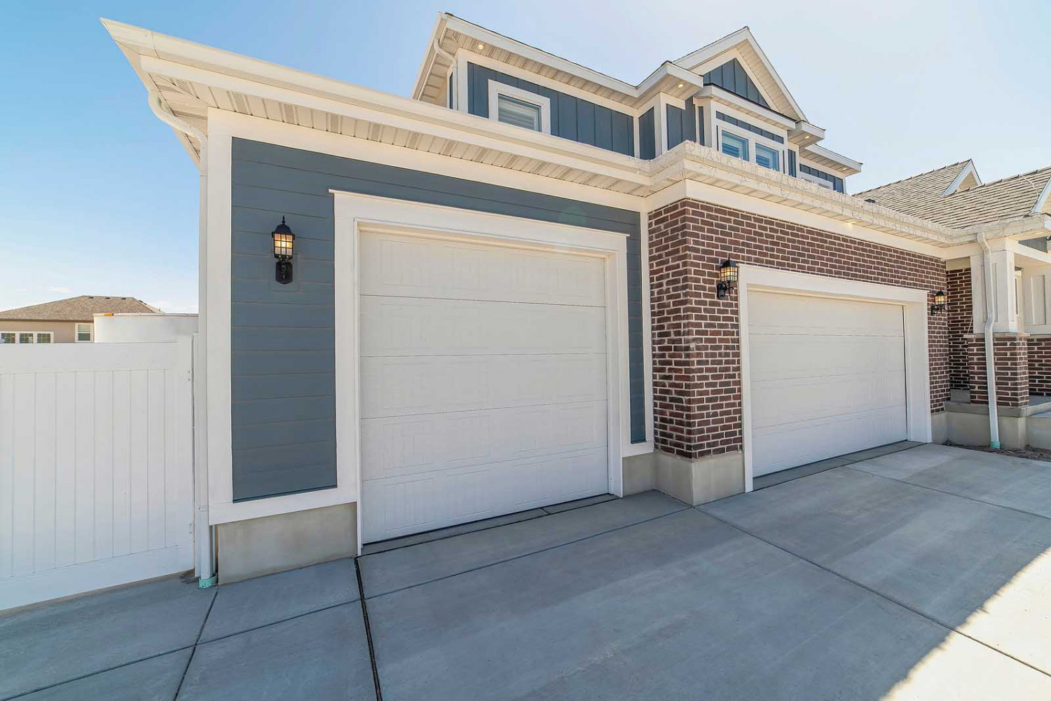 New insulated garage door installation on a suburban home